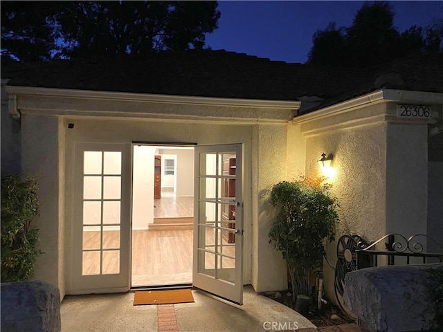 exterior entry at twilight featuring french doors