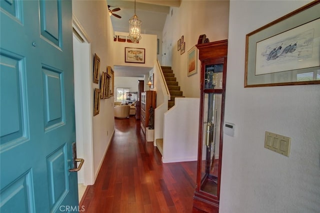 foyer with ceiling fan, dark wood-type flooring, and high vaulted ceiling