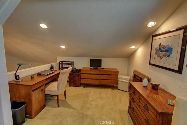 carpeted home office with lofted ceiling