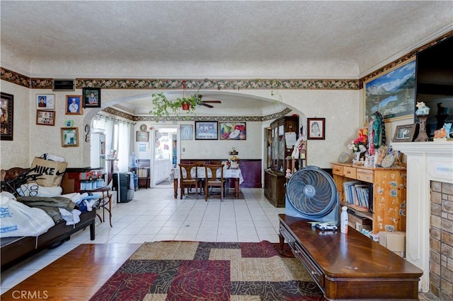 living room with light tile patterned floors and a textured ceiling