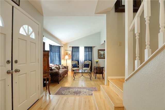 foyer entrance with hardwood / wood-style flooring and lofted ceiling