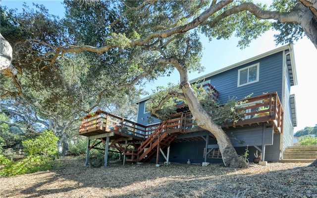 rear view of house featuring a wooden deck