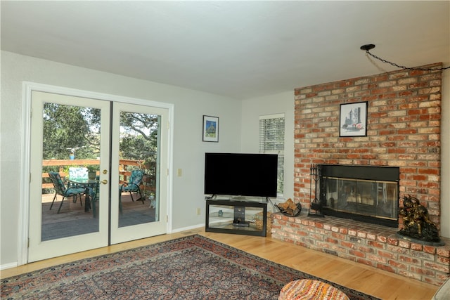 unfurnished living room with a fireplace, french doors, and hardwood / wood-style flooring