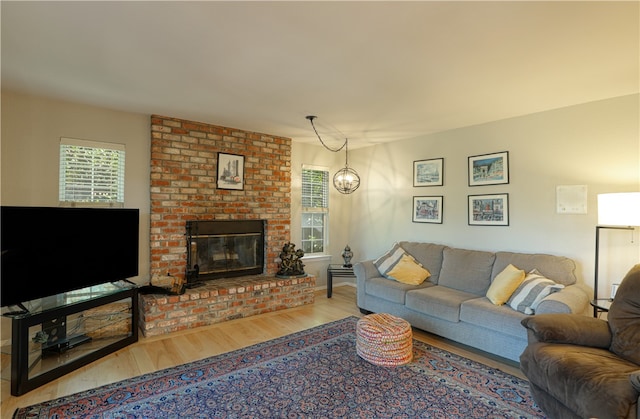 living room featuring a fireplace and light wood-type flooring