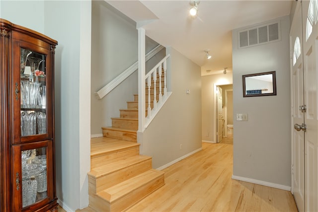 staircase featuring hardwood / wood-style flooring