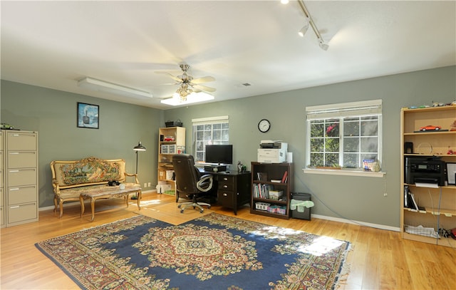 home office featuring ceiling fan, track lighting, and hardwood / wood-style floors