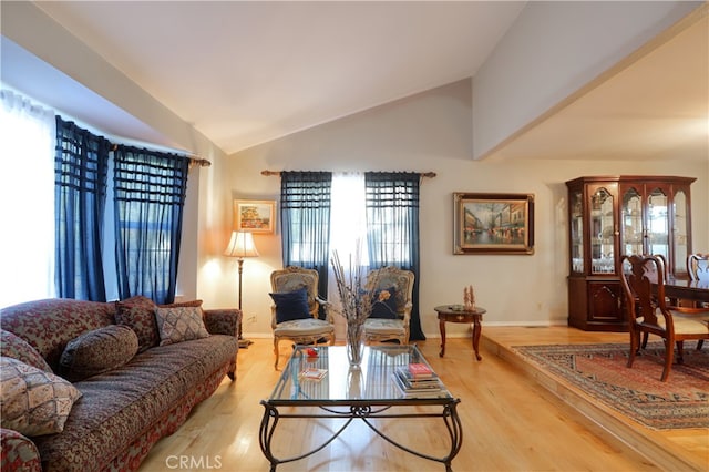 living room featuring hardwood / wood-style flooring and lofted ceiling