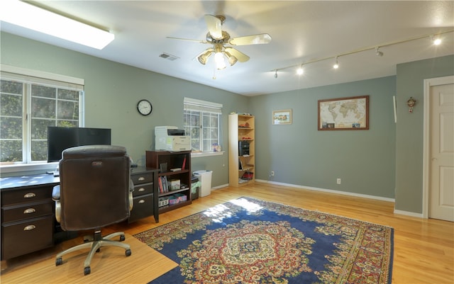 office area with ceiling fan, light wood-type flooring, and rail lighting