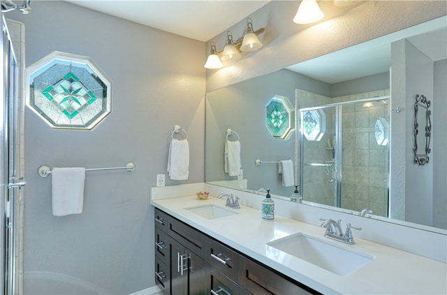 bathroom with walk in shower and vanity