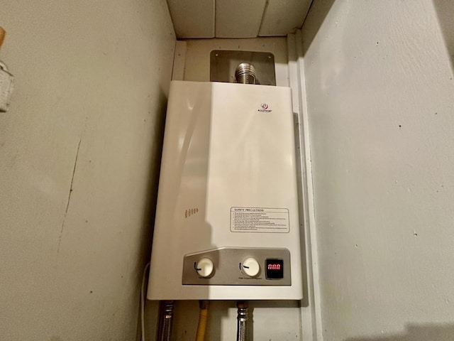 utility room featuring water heater