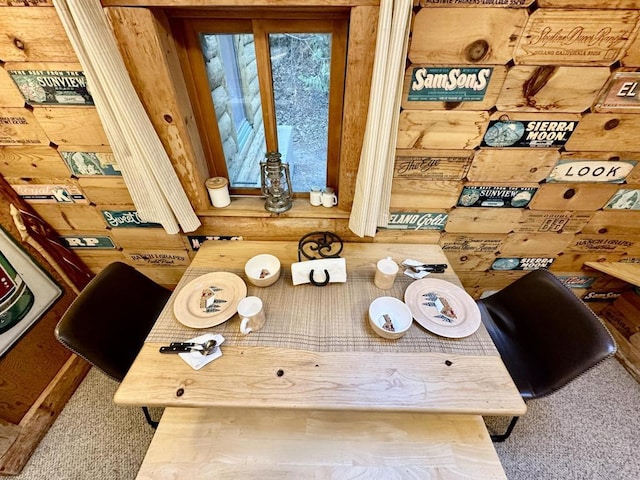 interior details featuring carpet floors and rustic walls