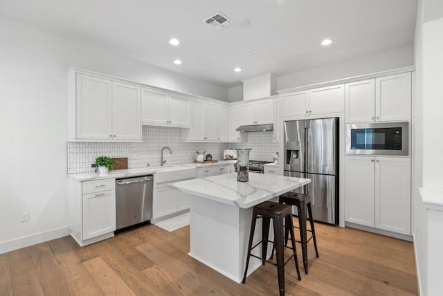 kitchen with sink, white cabinetry, and appliances with stainless steel finishes