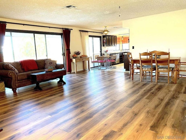 living room featuring plenty of natural light and dark wood-type flooring