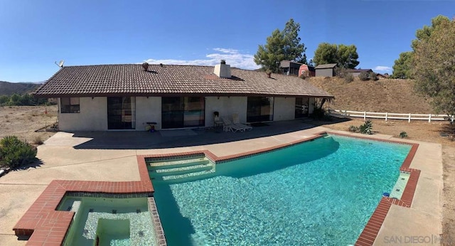 view of swimming pool featuring an in ground hot tub and a patio area