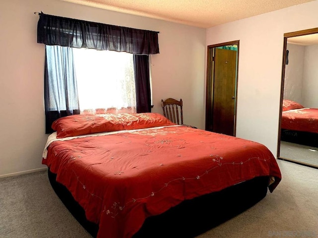 carpeted bedroom featuring a textured ceiling