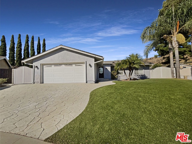 view of front of house with a front yard and a garage