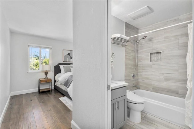 full bathroom with hardwood / wood-style flooring, shower / tub combo with curtain, vanity, and toilet