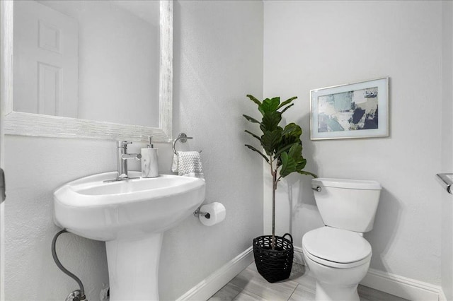 bathroom with tile patterned flooring and toilet