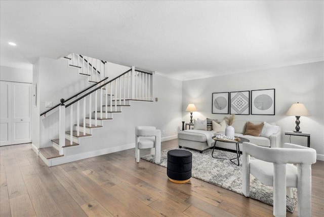 living room with hardwood / wood-style flooring and crown molding