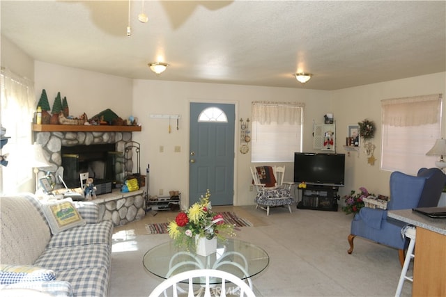 living room featuring a textured ceiling and a fireplace