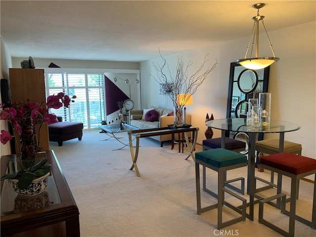 dining space featuring light carpet