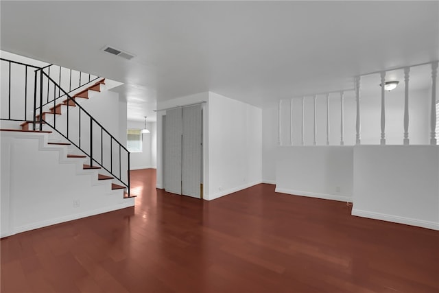 unfurnished living room featuring dark hardwood / wood-style floors