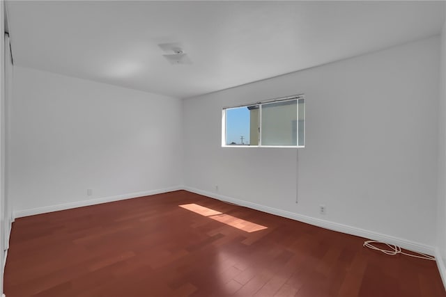 spare room featuring hardwood / wood-style flooring