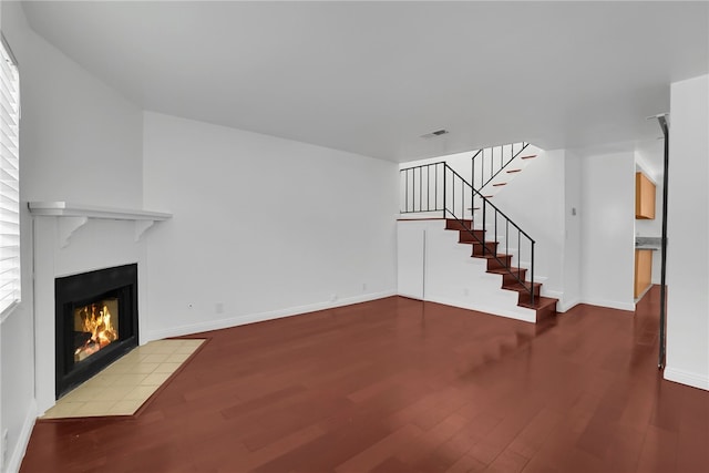 unfurnished living room with hardwood / wood-style flooring and plenty of natural light