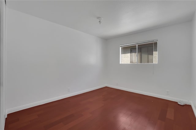 unfurnished room with wood-type flooring