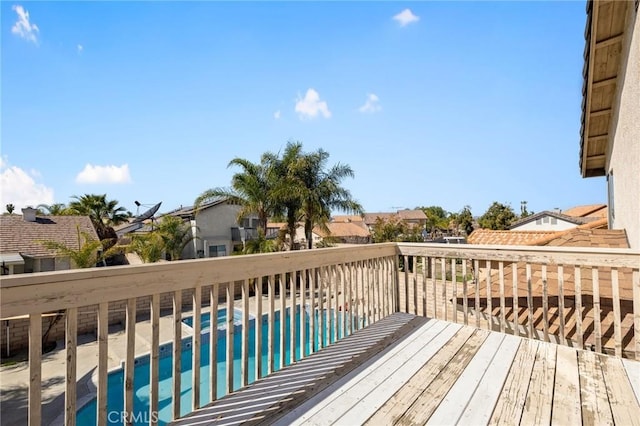 wooden terrace featuring a residential view and a fenced in pool