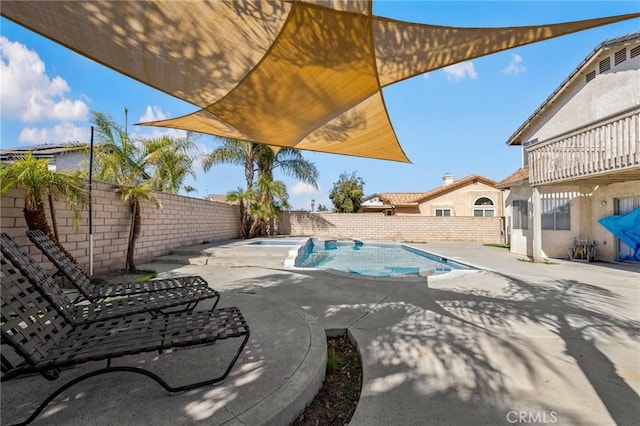 view of pool with a fenced in pool, a fenced backyard, a patio, and an in ground hot tub