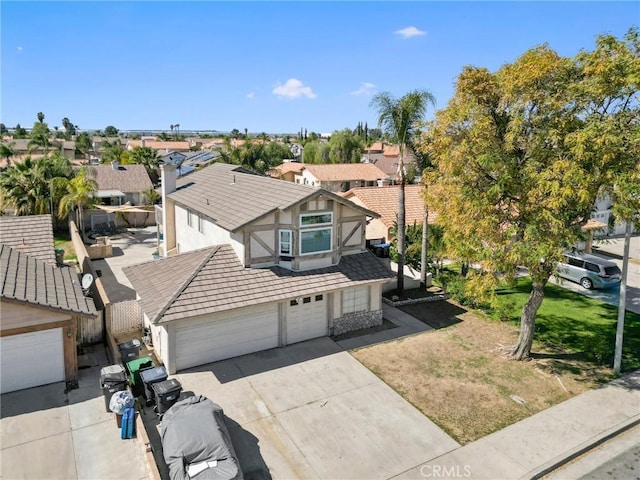 view of front of home featuring a residential view, driveway, a tiled roof, and stucco siding