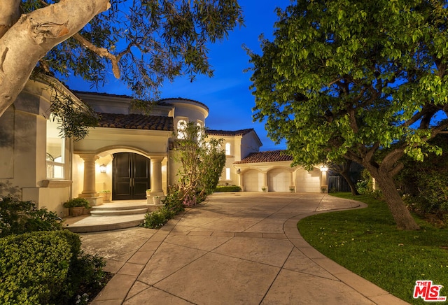 mediterranean / spanish-style house featuring a garage