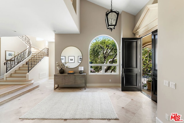 foyer featuring plenty of natural light and a towering ceiling