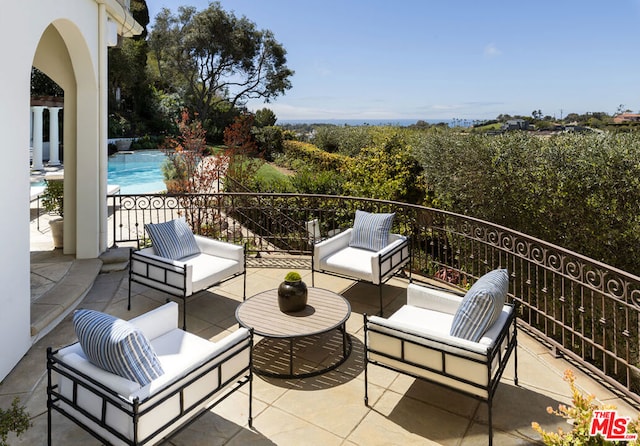 view of patio with an outdoor living space and a fenced in pool