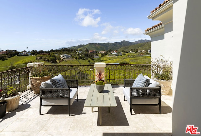 view of patio / terrace with a mountain view, outdoor lounge area, and a balcony