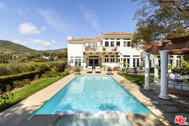 rear view of house featuring a patio, a balcony, a mountain view, and a pergola