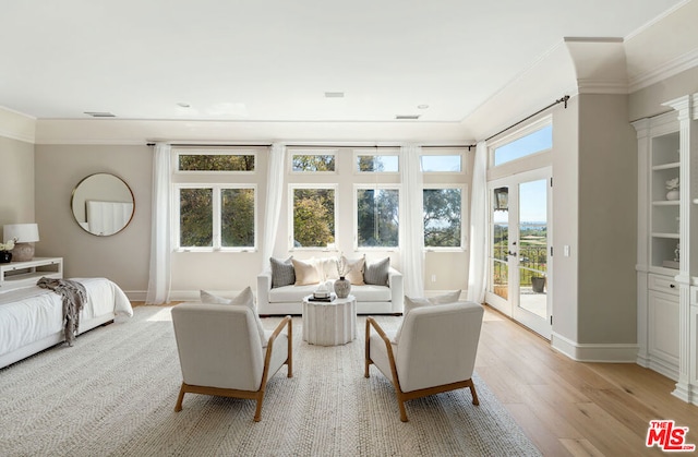 bedroom featuring crown molding, access to outside, and light hardwood / wood-style floors