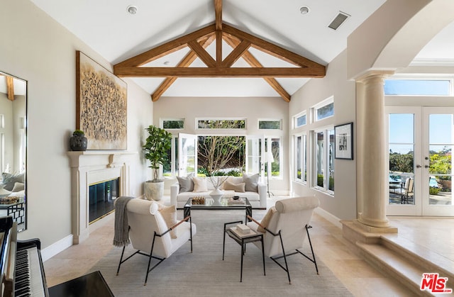 living room with french doors, a healthy amount of sunlight, high vaulted ceiling, and decorative columns