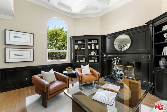 sitting room with crown molding, coffered ceiling, beam ceiling, and light hardwood / wood-style flooring