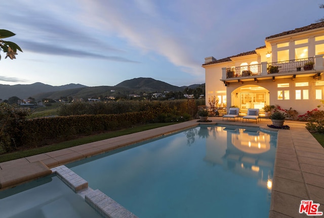 pool at dusk with a mountain view