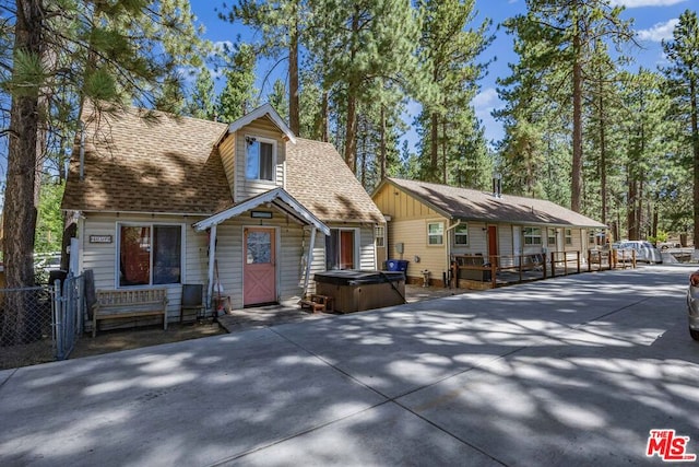 view of front of home featuring a hot tub and a deck