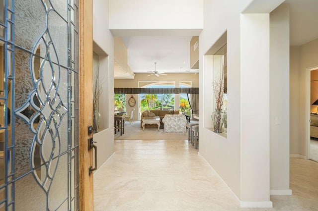 foyer entrance with ceiling fan