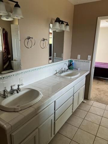 bathroom with tile patterned floors and vanity