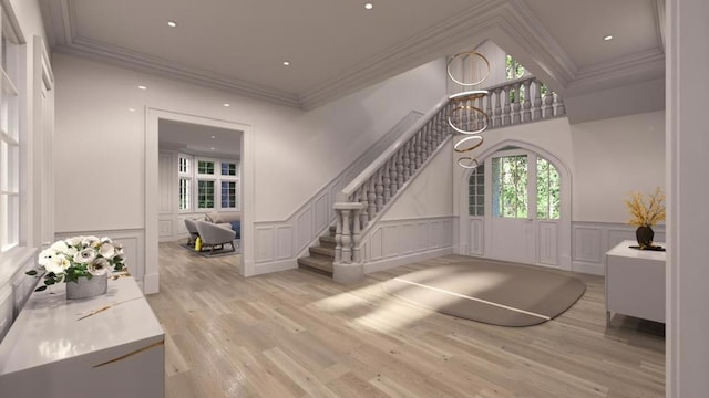 entrance foyer featuring light hardwood / wood-style floors and crown molding