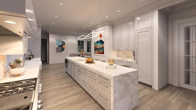 kitchen with a center island, light stone counters, light wood-type flooring, and white cabinetry