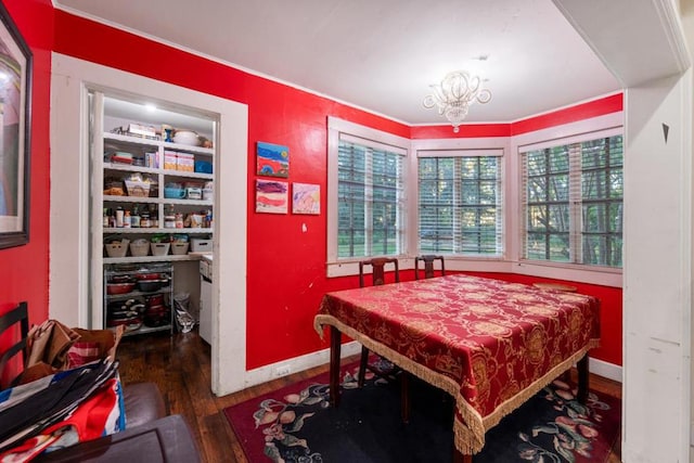 dining space with dark hardwood / wood-style floors and a notable chandelier