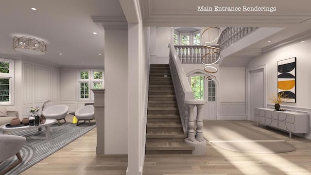 staircase featuring hardwood / wood-style floors, crown molding, and a wealth of natural light