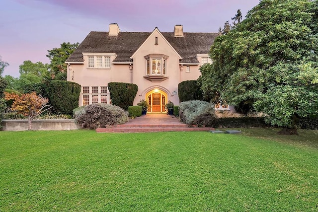 french country home with a lawn and french doors