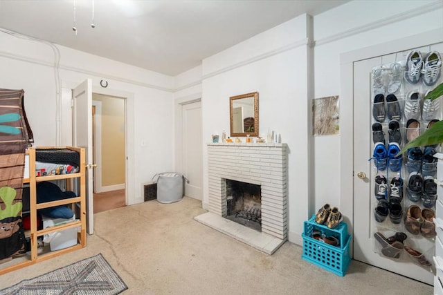 carpeted living room with a brick fireplace